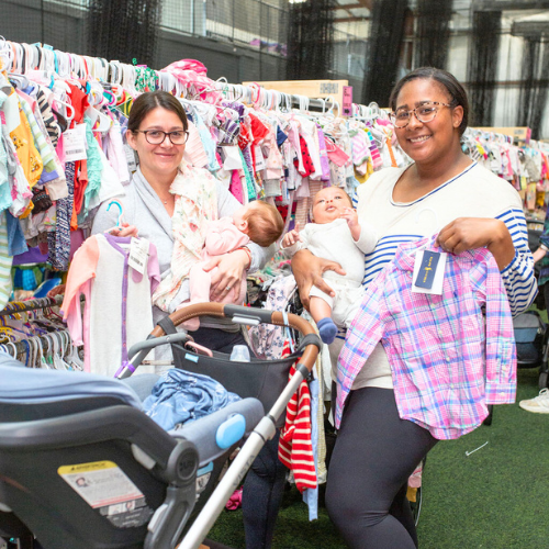 A mom, abuela and granddaughter attend a JBF sale in Dallas. Abuela is holding a babyseat.